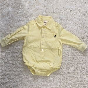 Osh Kosh baby boy’s yellow collared bodysuit.